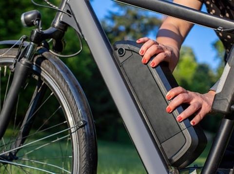 Person fitting an electric bike battery.