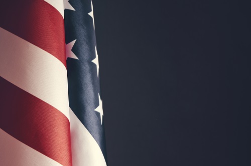 US Flag Against Dark Background MED Istock 1365529691 Credit Dmitriy83