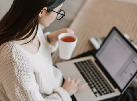 Woman working on a laptop.